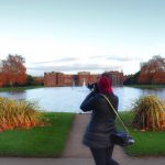Woman taking photos in Kensington Palace Gardens