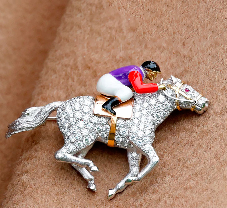 Queen Camilla's horse and jockey brooch.
