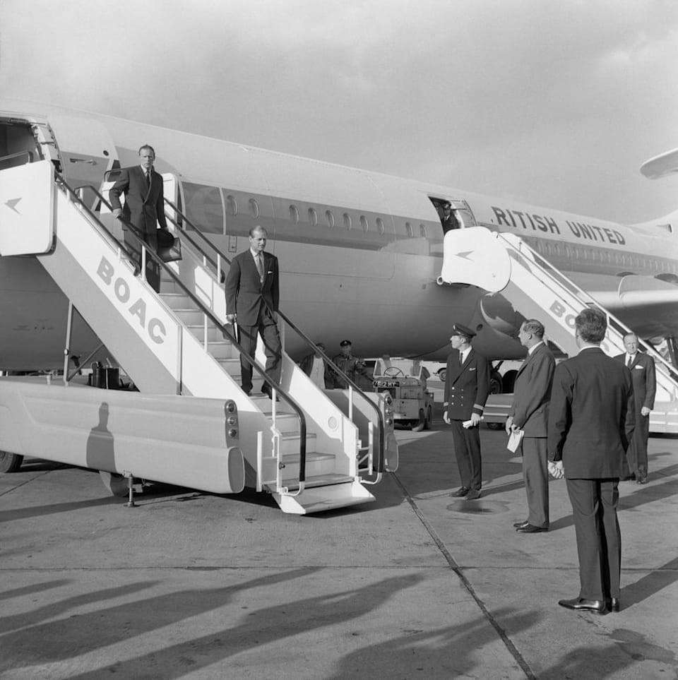 Michael's father Captain Peter can be seen in uniform to the right of the steps as Prince Philip disembarks