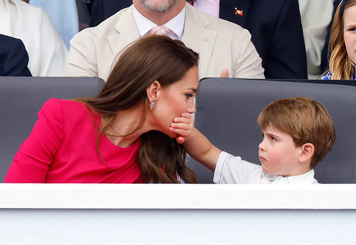 Prince Louis covering his mother's mouth.