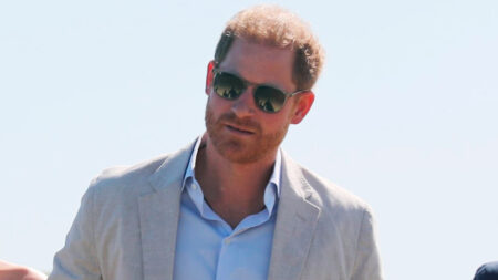 Prince Harry wiping his nose with his hands