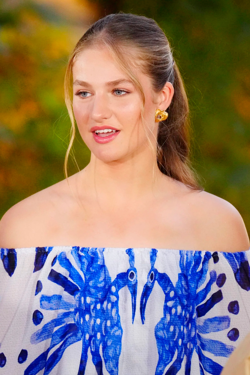 Princess Leonor wears a blue-toned print dress with a Bardot neckline.