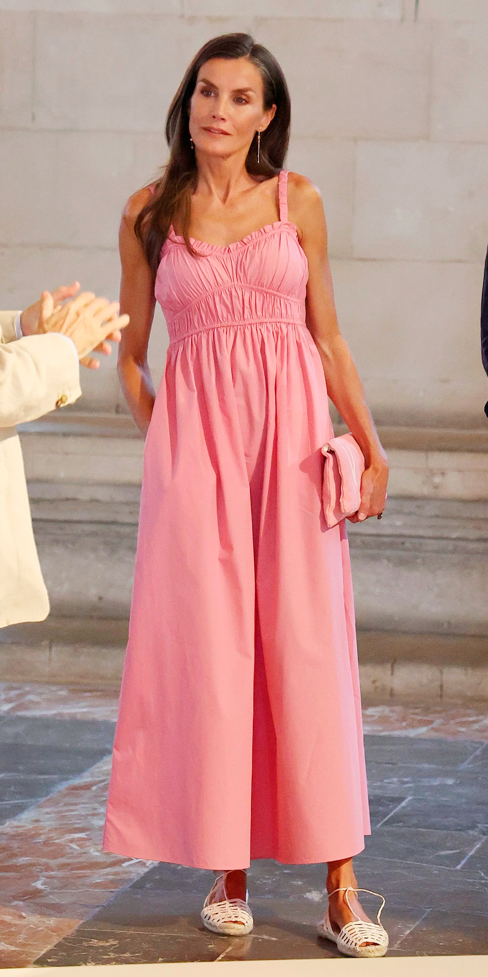 Queen Letizia wears a pink dress by Hugo Boss.