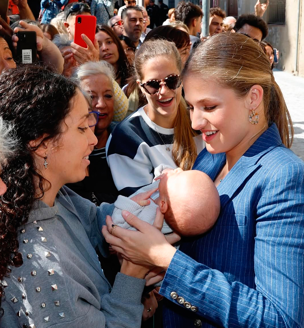 Princess Leonor carrying a baby.