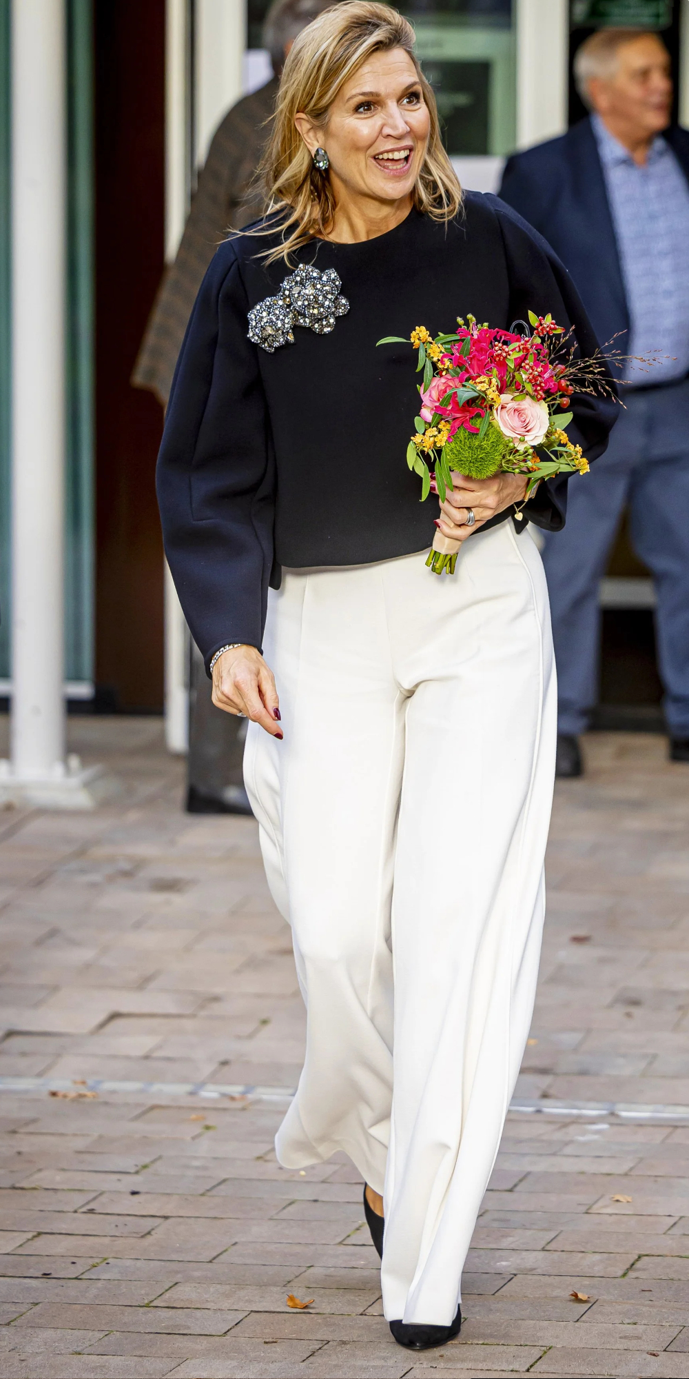 Maxima wears a Natan outfit and Gianvito Rossi heels.