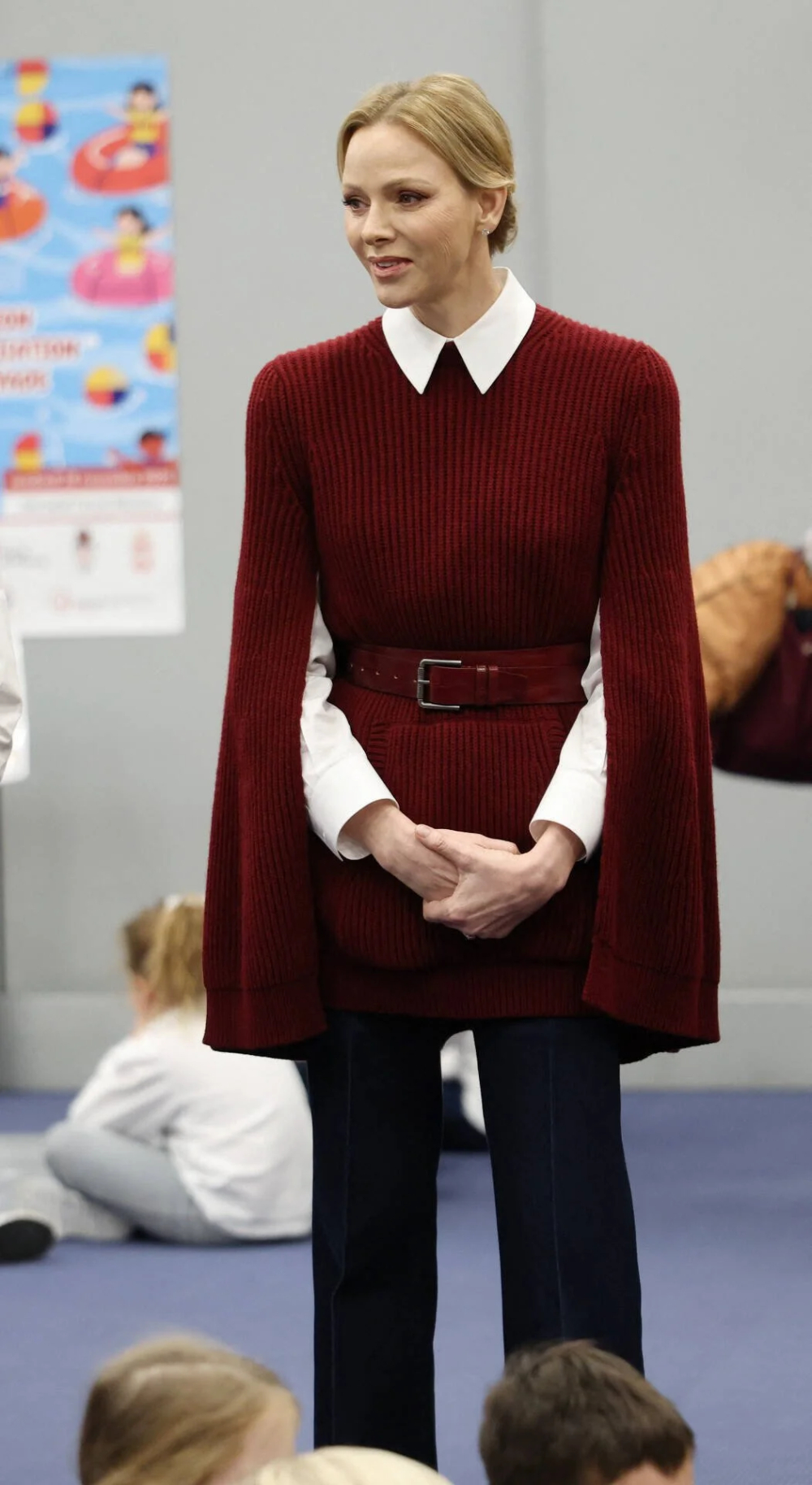 Charlene wears a cape by Max Mara