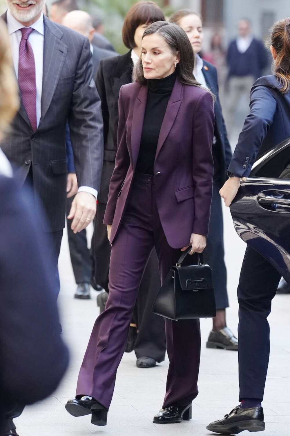 Queen Letizia Wears a Wine-Colored Hugo Boss Suit During Her Visit to Valencia Queen Letizia wore a Hugo Boss suit with her Massimo Dutti shoes and her Carolina Herrera bag.