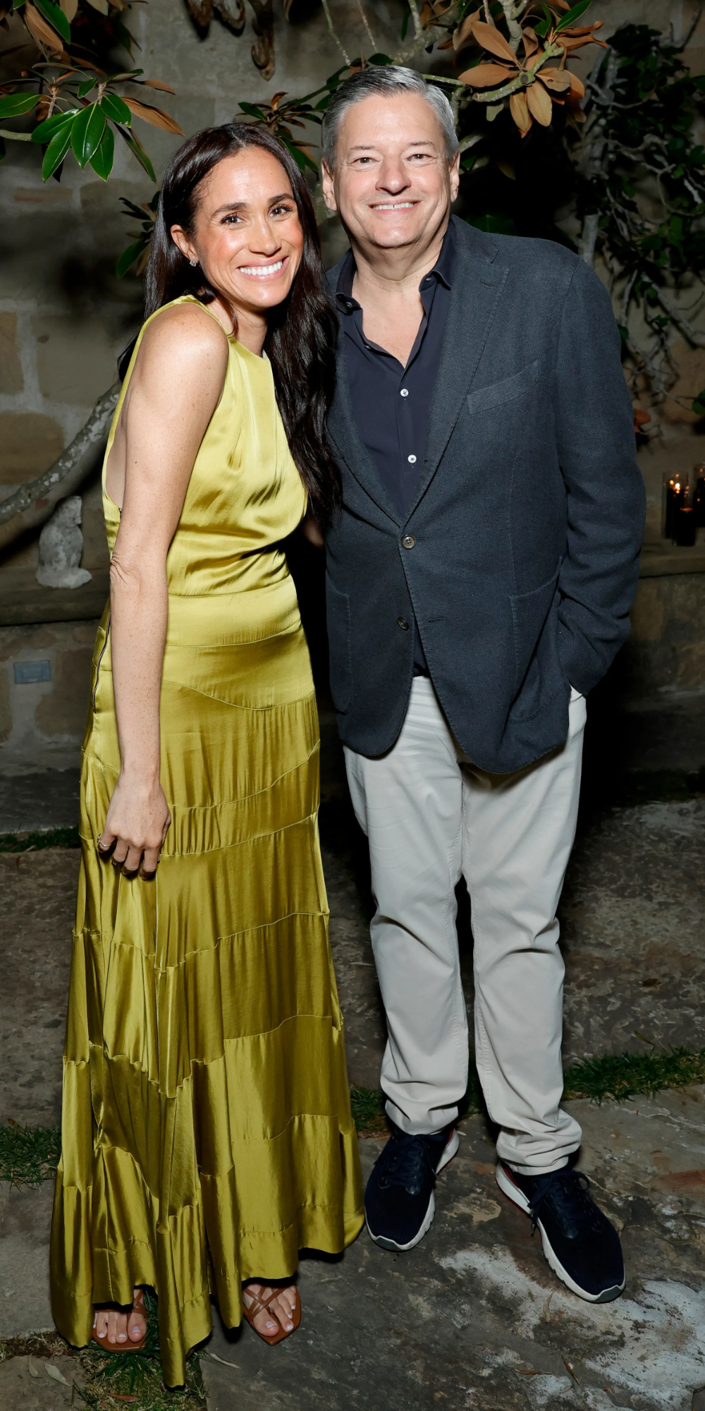 Meghan Markle Wore a Chartreuse Heidi Merrick Dress to a Netflix Event Meghan Markle with Ted Sarandos.