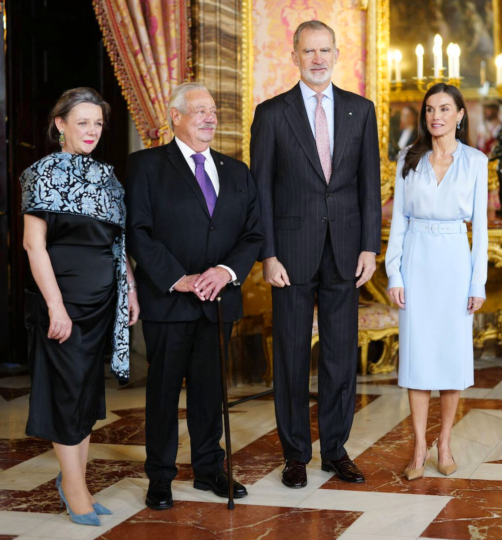 Queen Letizia Pairs a Hugo Boss Pencil Skirt with a Luxe Silk Blouse for Her Latest Outing The King and Queen with the writer Gonzalo Cerolio and his wife.