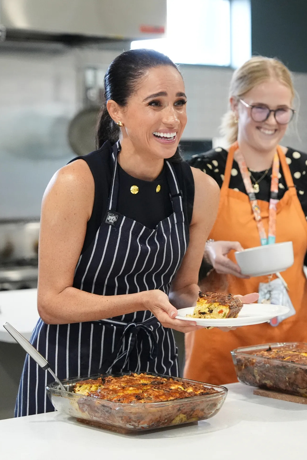 Why Meghan Markle’s MasterChef Australia Cameo Is a Major Strategic Power Move Meghan Markle cooking at a women's shelter in Australia.
