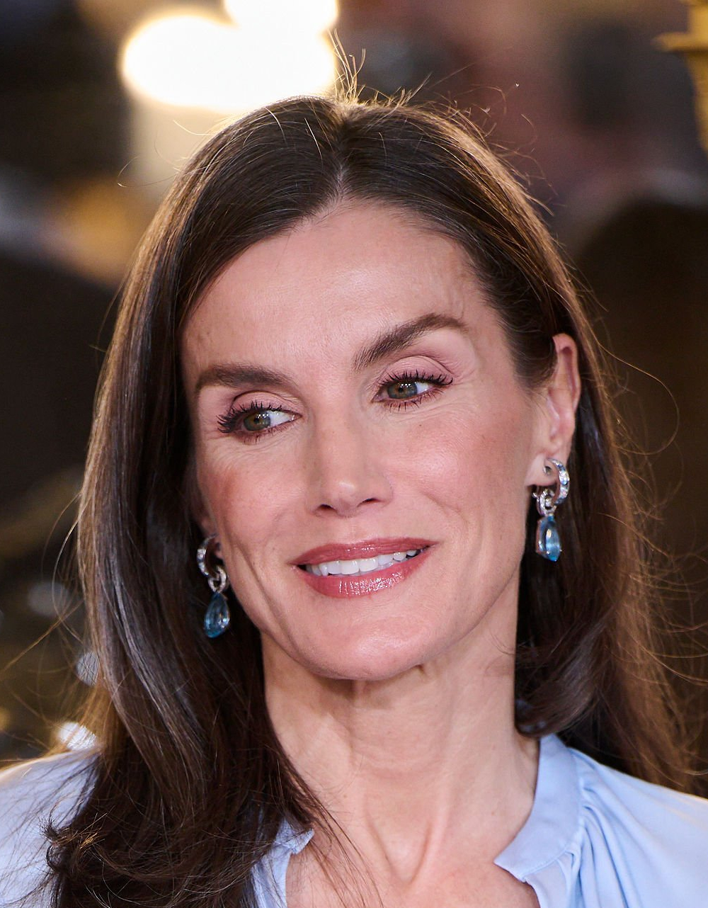 Queen Letizia Pairs a Hugo Boss Pencil Skirt with a Luxe Silk Blouse for Her Latest Outing Queen Letizia is wearing Aldao's aquamarine earrings.